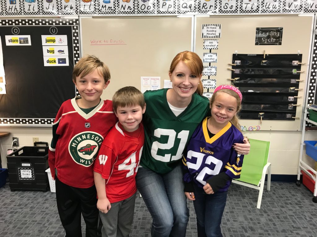 A group of elementary students in their favorite sports jerseys.