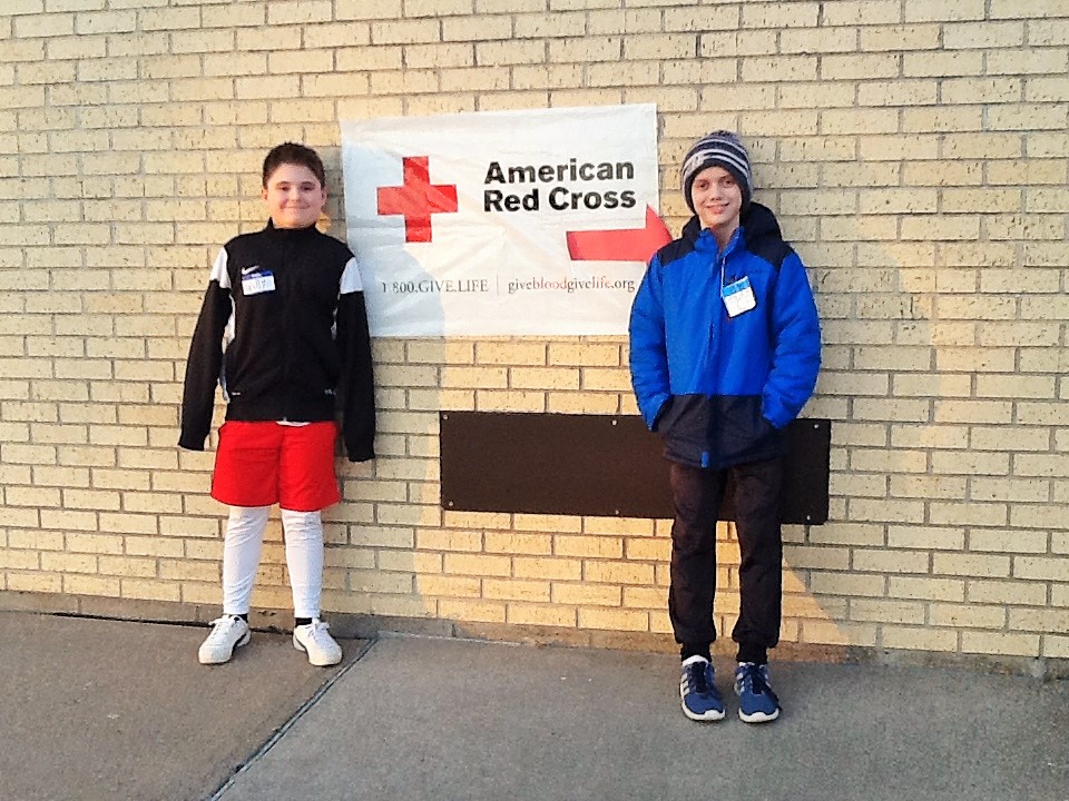 Houlton National Elementary Honor Society students pose next to sign for blood drive.
