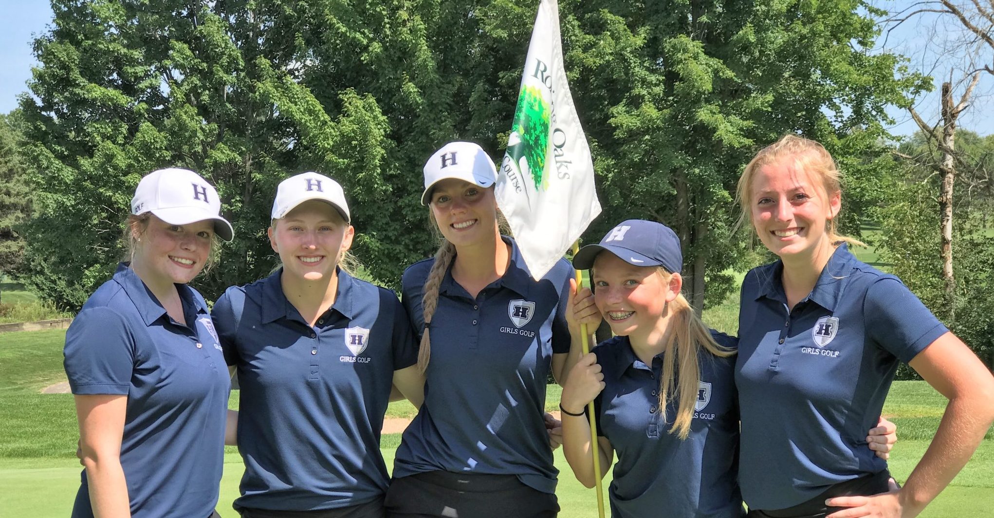 Five members of the girls golf team pose following their game.