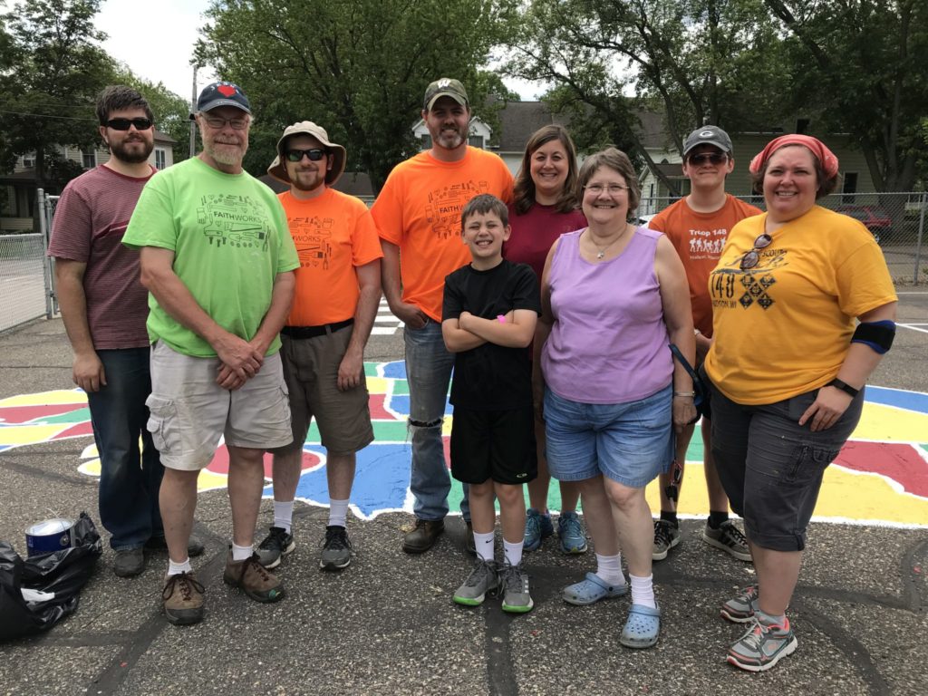 Volunteers from Faith Community Church's Faithworks gather for a group photo on the Willow River Elementary School playground.