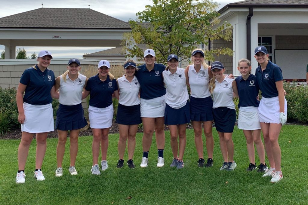 Members of the girls golf team standing together in a line.