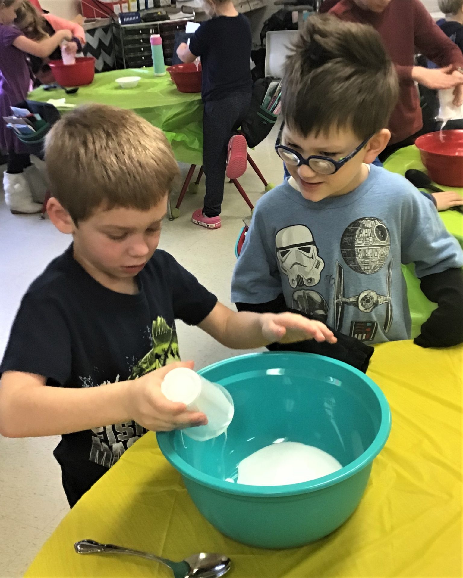 Two students mixing slime.