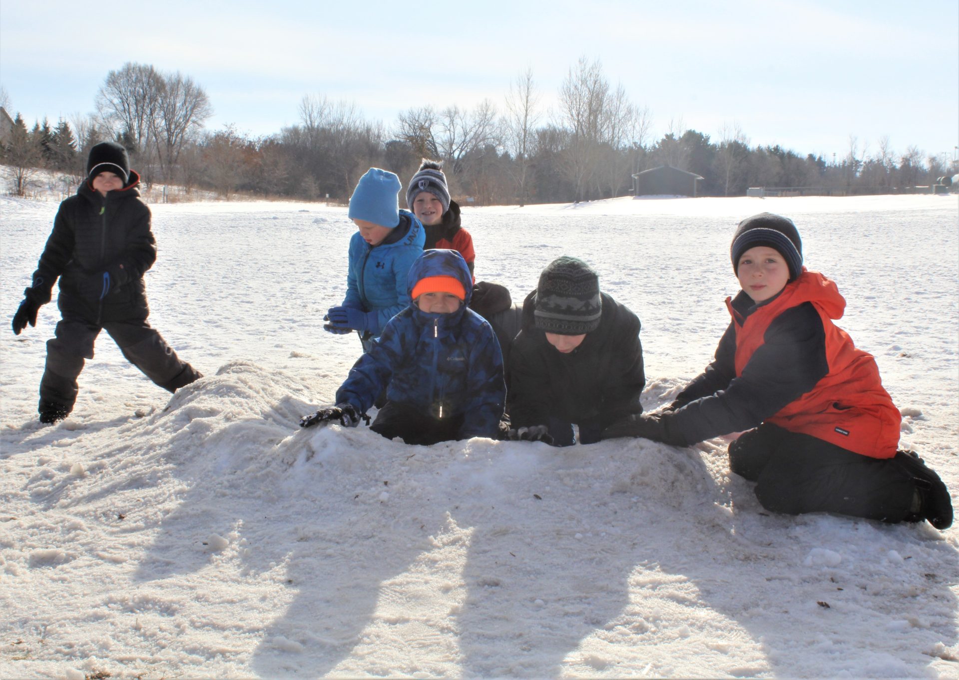 A group of boys playing in the snow.