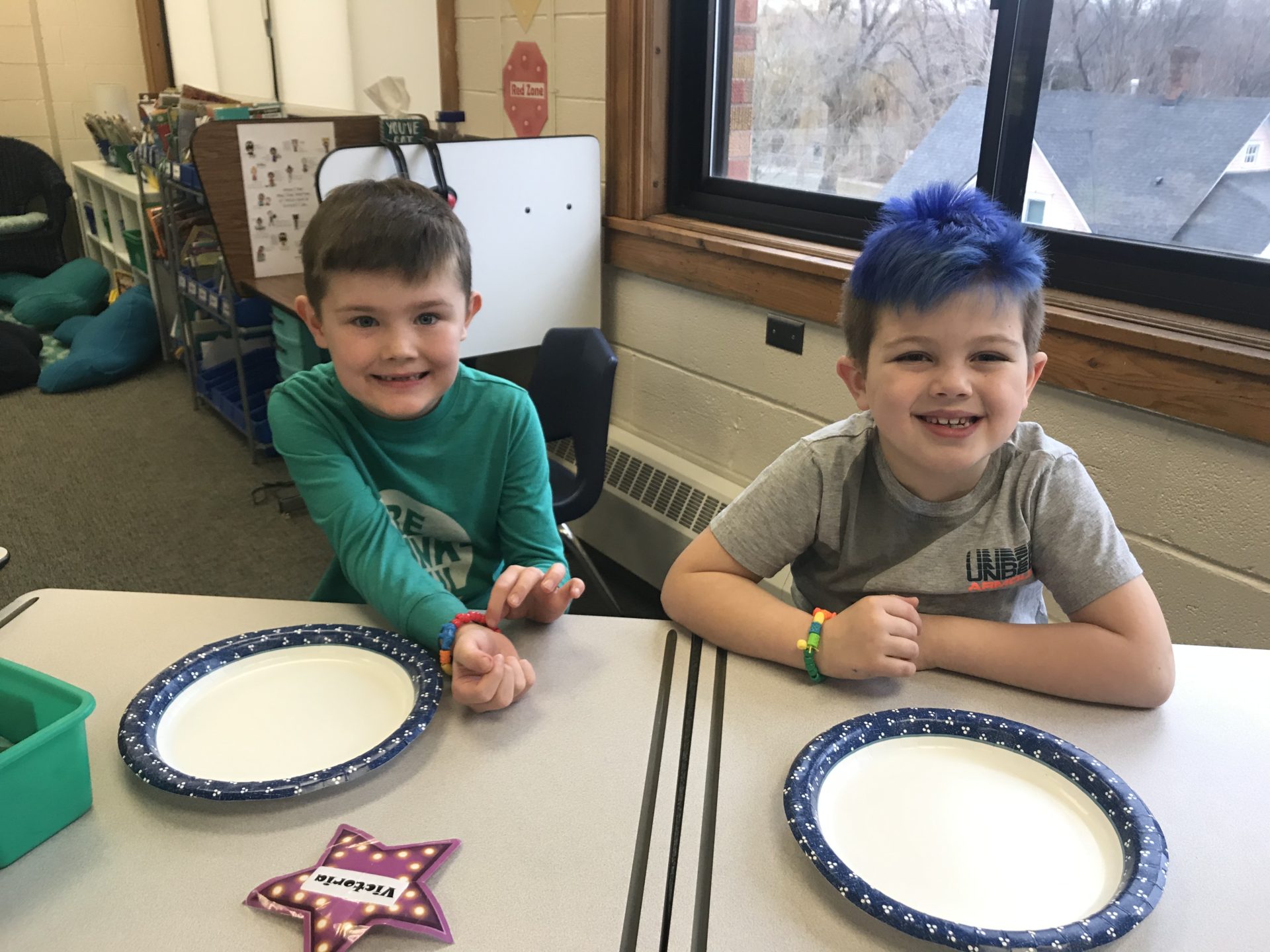 Two students show off their friendship bracelets. 