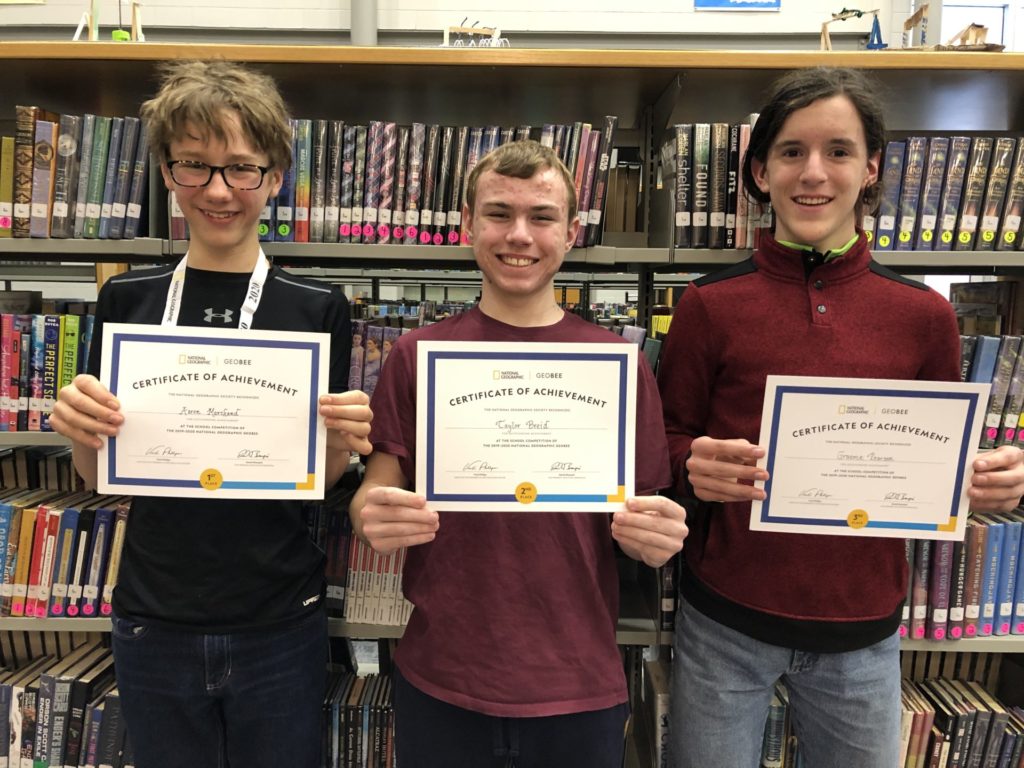 Three students hold up their GeoBee awards.