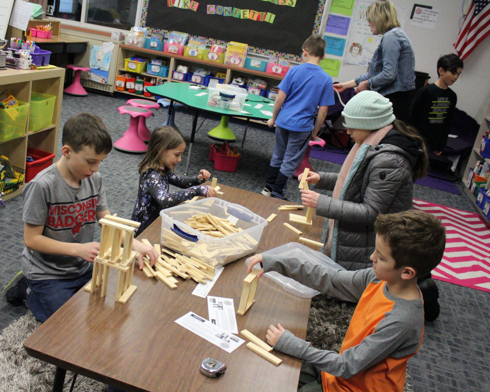 A group of students building with small wooden blocks.