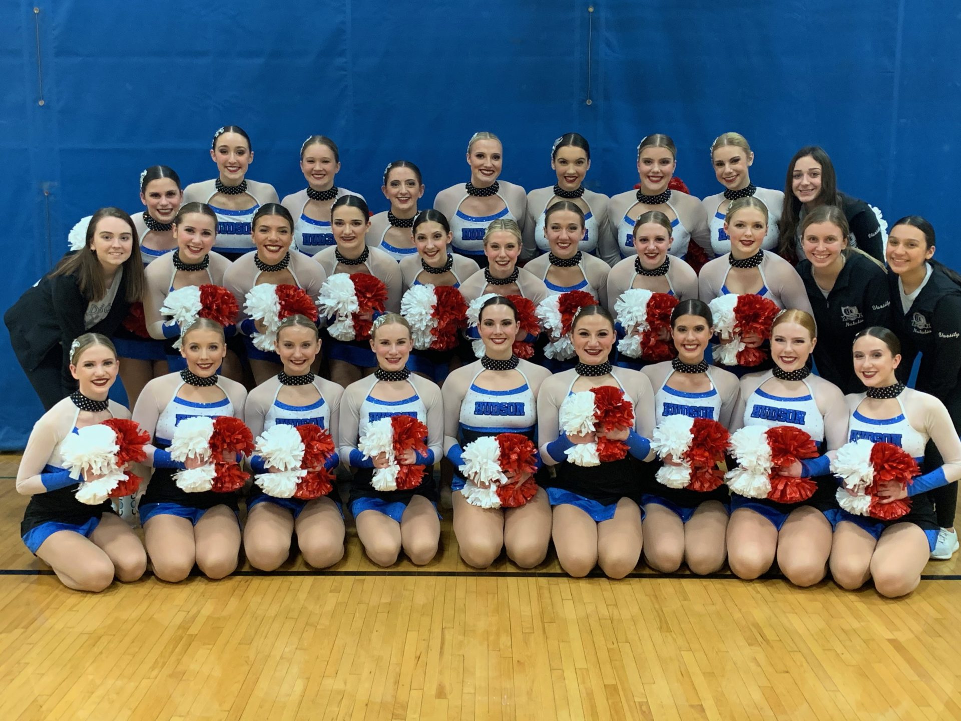 Team posing in red white and blue