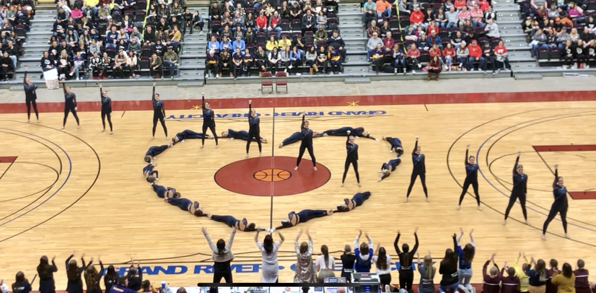 Team performing in a heart shape.