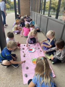 Students painting their rocks for the Peace Garden.