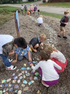 Students placing their rocks in the Peace Garden.