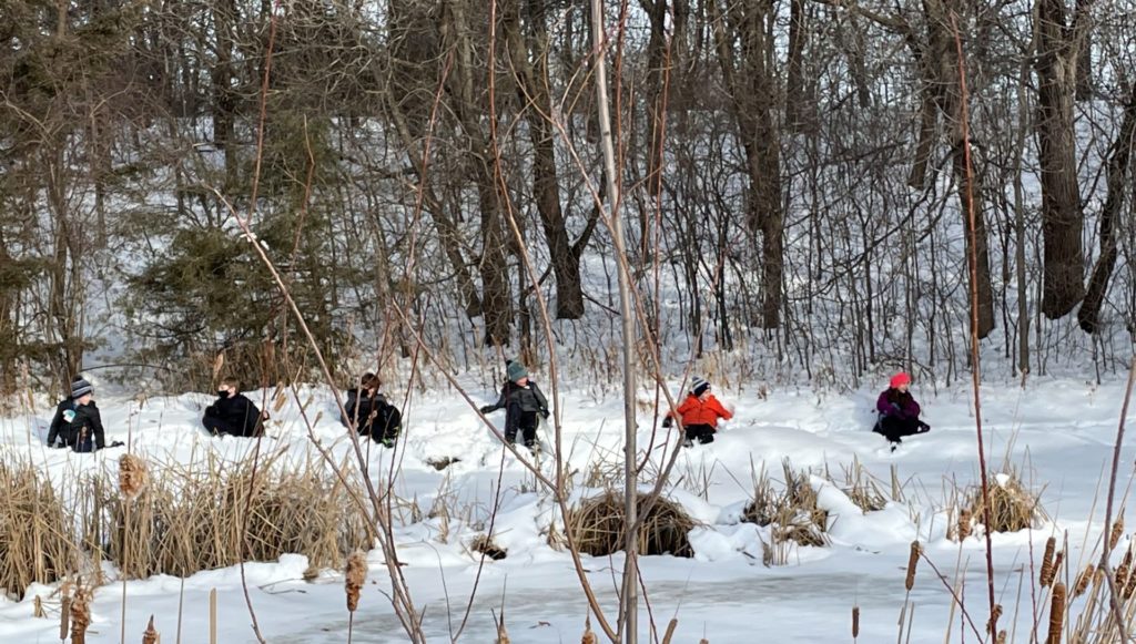 A group of children near the frozen pond.