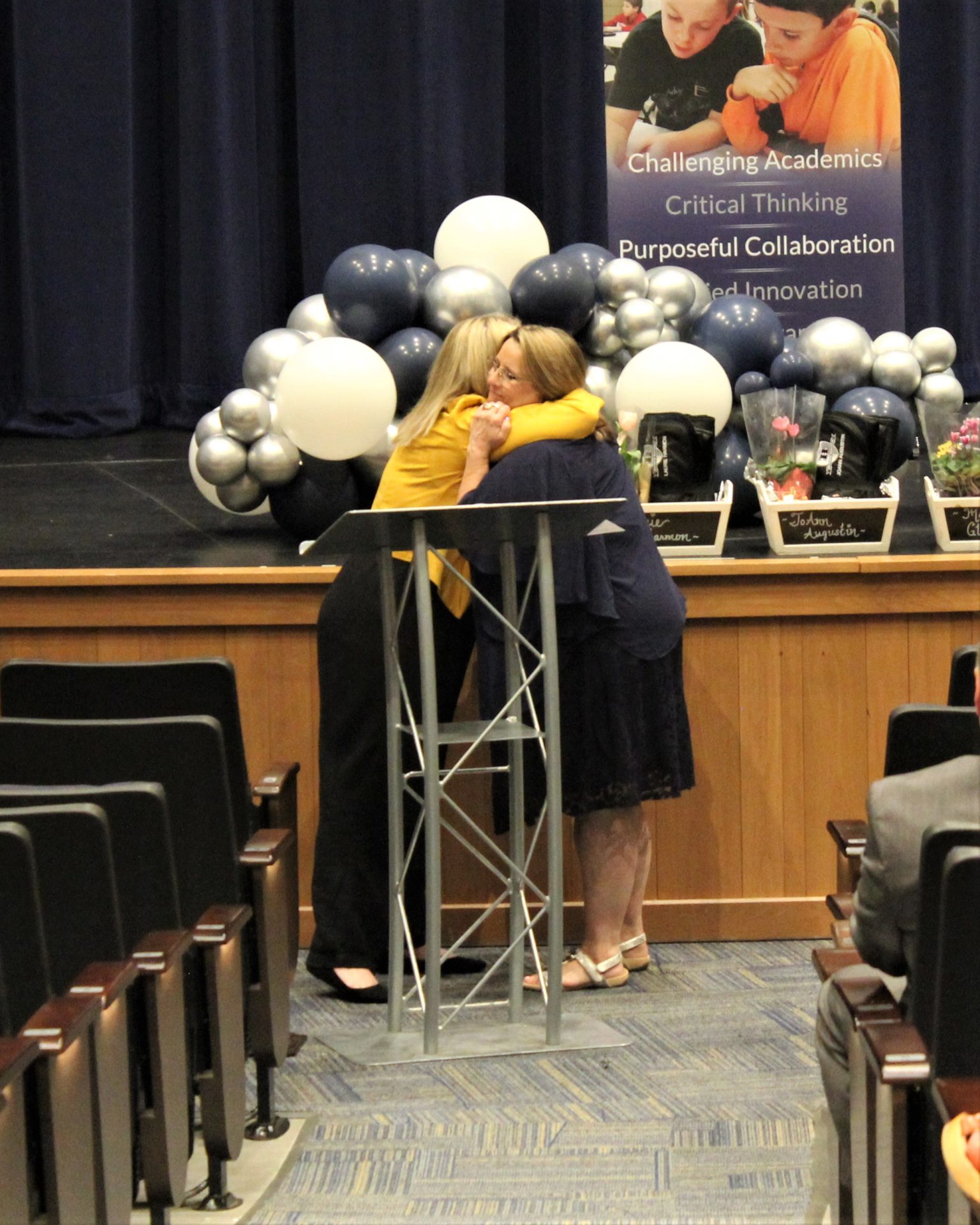 Nikki Benson hugs retiree Laurie Harmon.