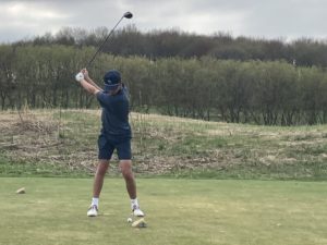 Image of Nic Logan swinging a golf club
