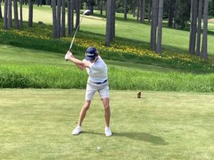 Image of Oscar Grothaus swinging a golf club