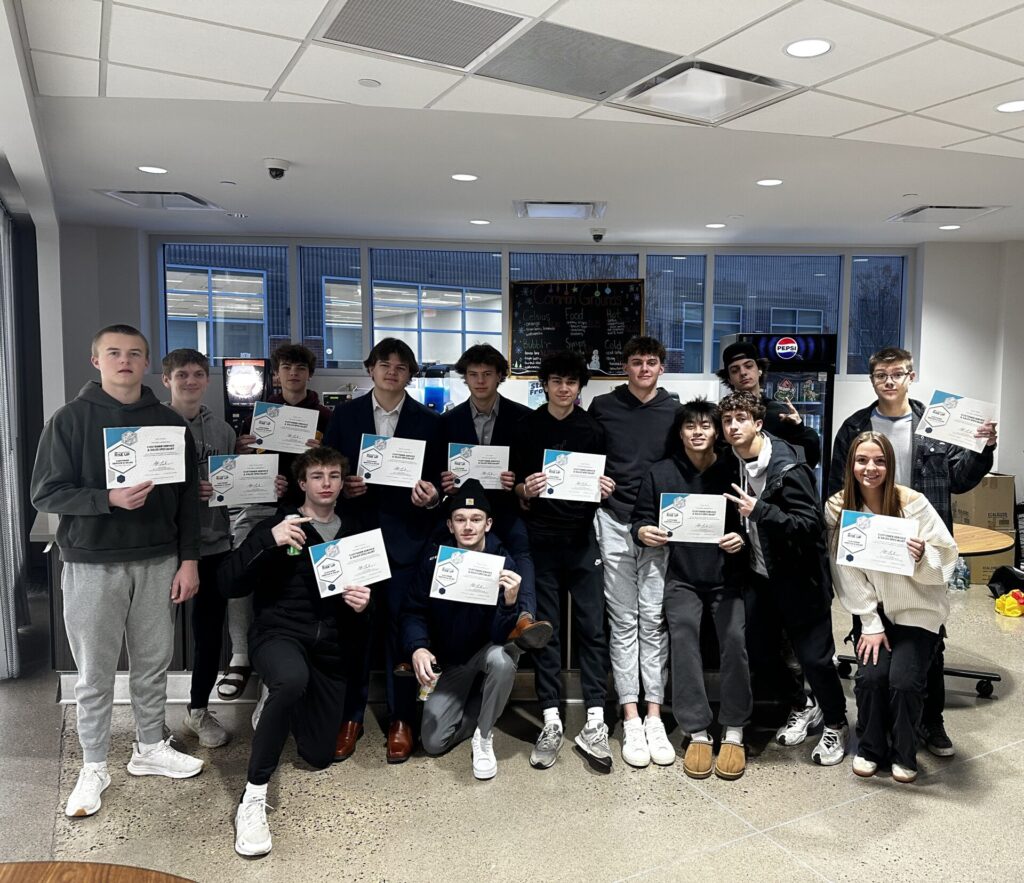 A group of students pose with their certifications.